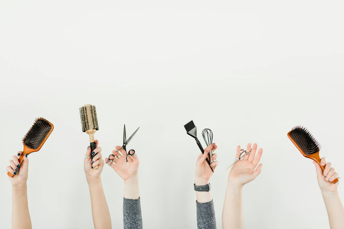 salon-grade flat irons showing dual-zone ceramic-titanium plates with digital temperature display on a marble vanity